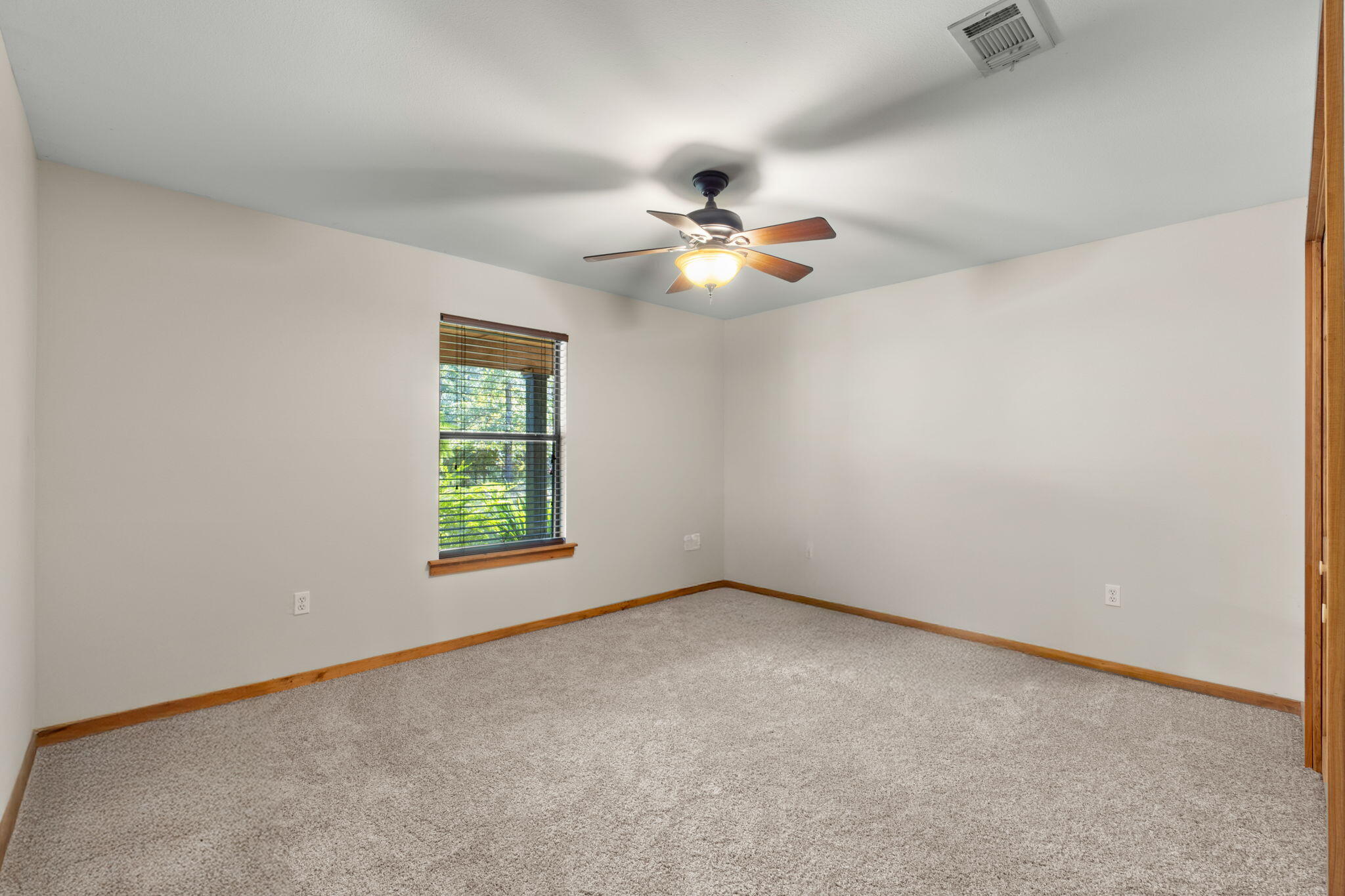 3350 New Ebenezer Road Laurel Hill, FL 32567 - Photo 18 of 53 an empty room with windows and fan