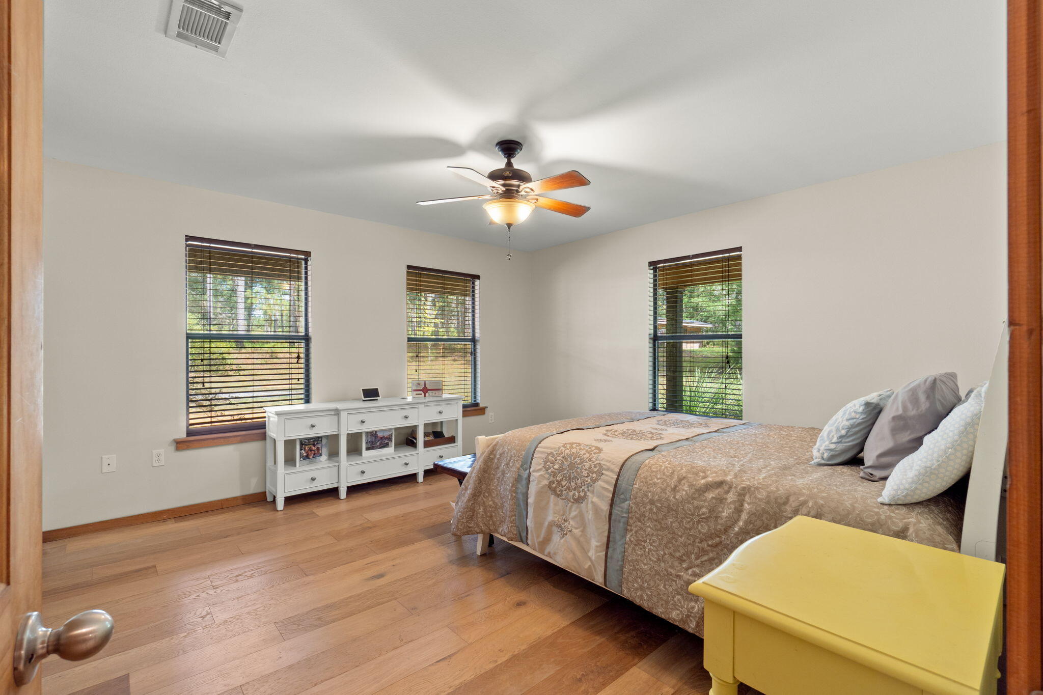 3350 New Ebenezer Road Laurel Hill, FL 32567 - Photo 23 of 53 a bedroom with a bed and a chandelier