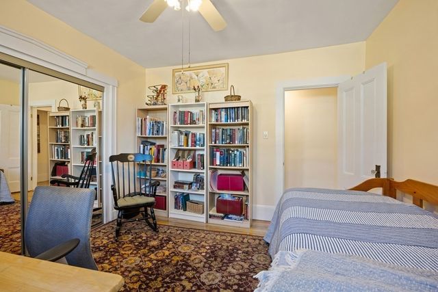 a bedroom with furniture and a book shelf