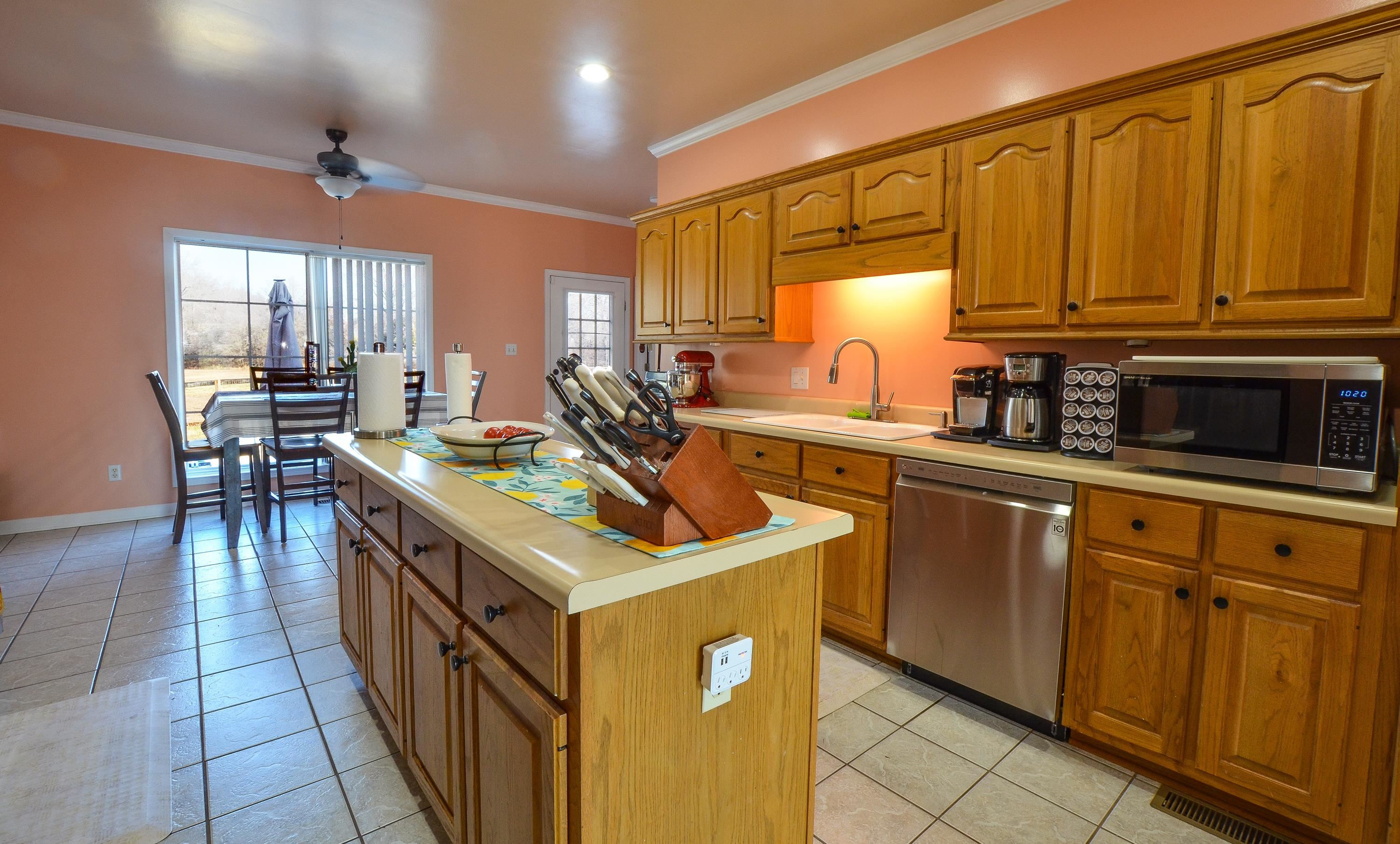 448 Plomar Williams Road Gadsden, TN 38337 - Photo 12 of 28 a kitchen with stainless steel appliances granite countertop a sink a stove and a refrigerator