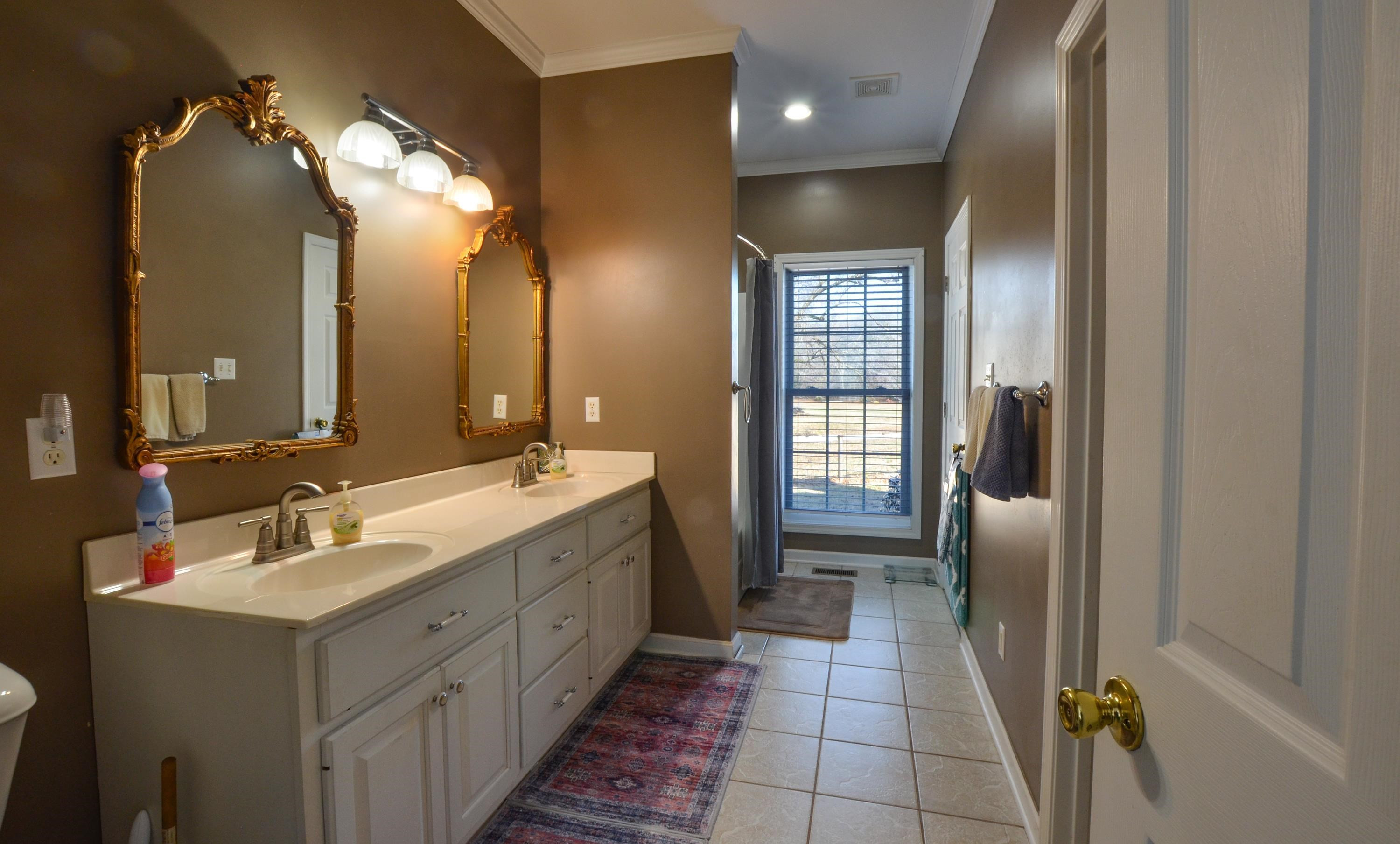 448 Plomar Williams Road Gadsden, TN 38337 - Photo 16 of 28 a bathroom with a double vanity sink and a mirror