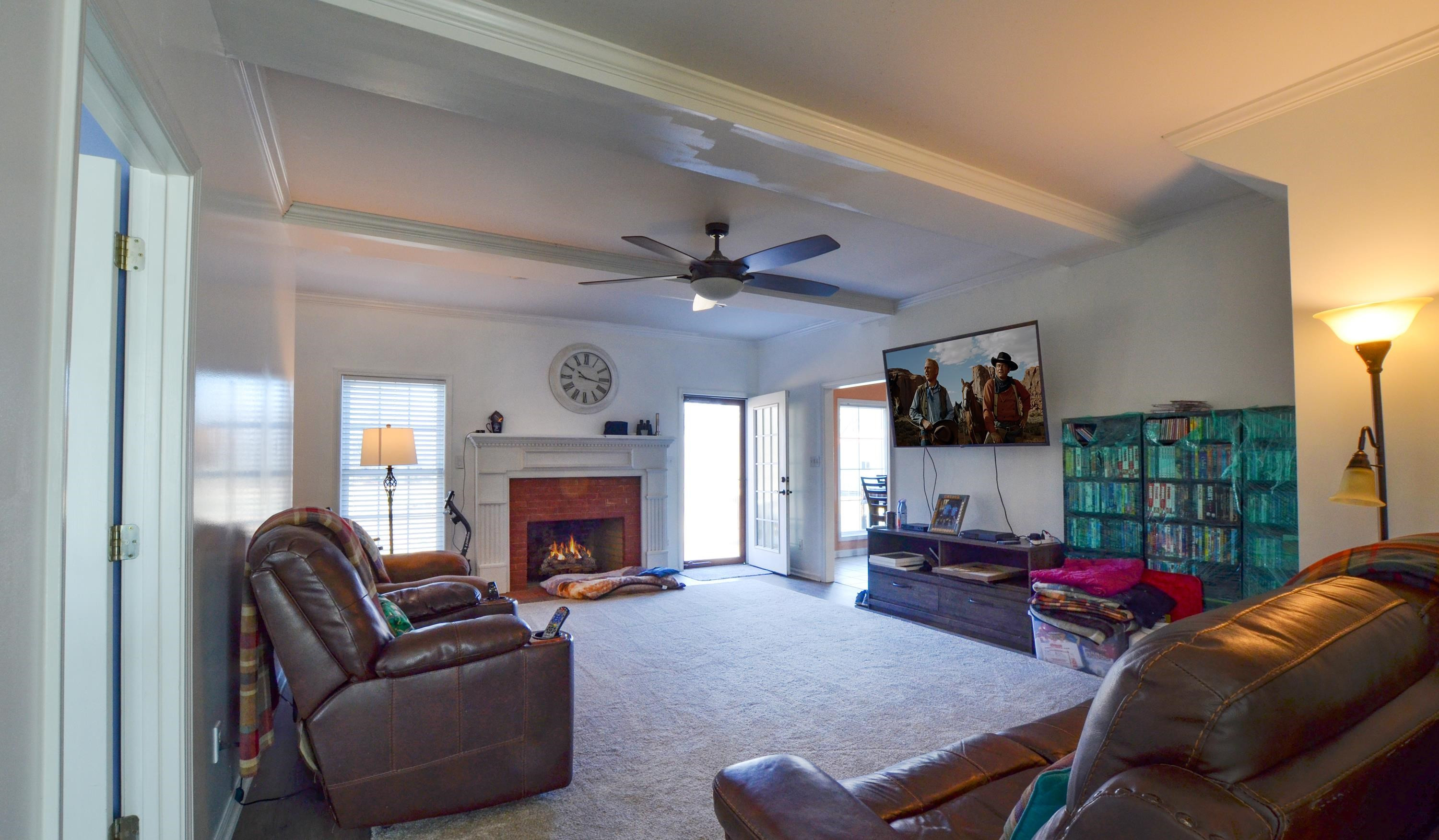 448 Plomar Williams Road Gadsden, TN 38337 - Photo 5 of 28 a living room with furniture a fireplace and a flat screen tv