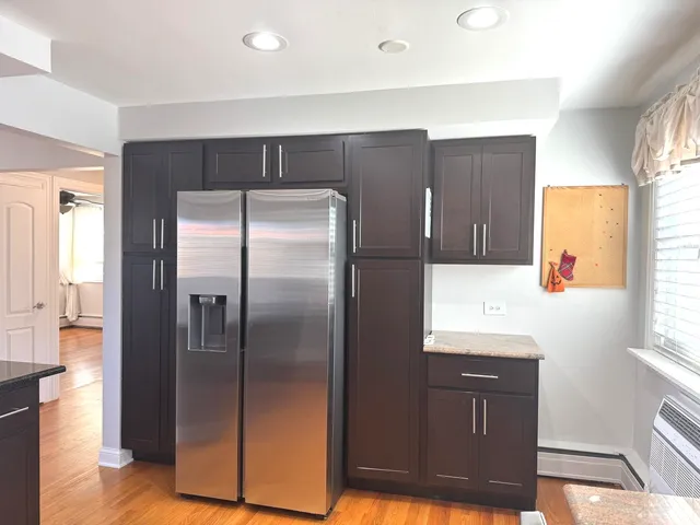 a kitchen with stainless steel appliances granite countertop a refrigerator and a sink