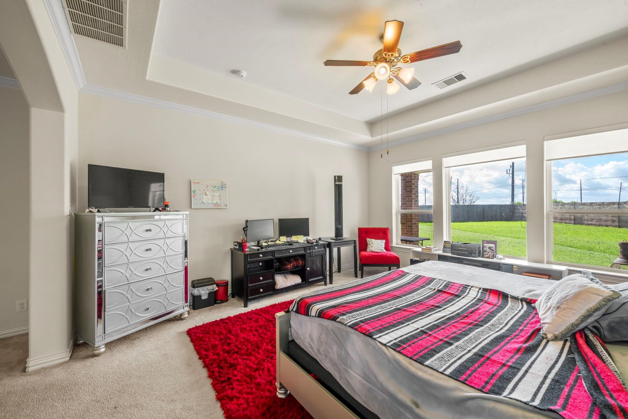 9939 Clear Diamond Drive Rosharon, TX 77583 - Photo 16 of 30 a room with a bed a flat screen tv and a larger window