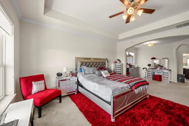 a bedroom with furniture and a flat screen tv