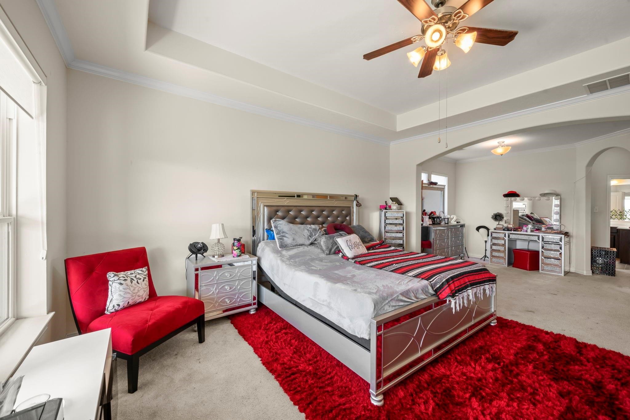 9939 Clear Diamond Drive Rosharon, TX 77583 - Photo 17 of 30 a bed room with a bed and a chandelier