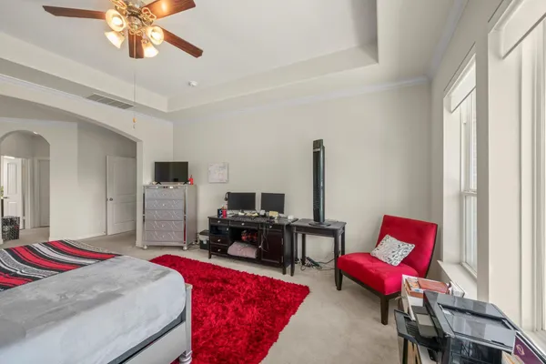 a room with kitchen island a stove a sink and a refrigerator