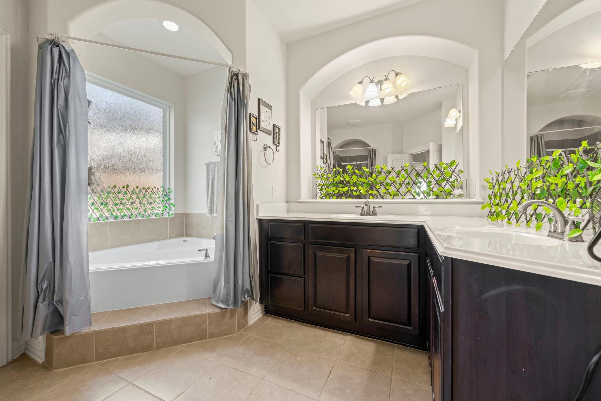 9939 Clear Diamond Drive Rosharon, TX 77583 - Photo 20 of 30 a bathroom with a bathtub sink and a mirror