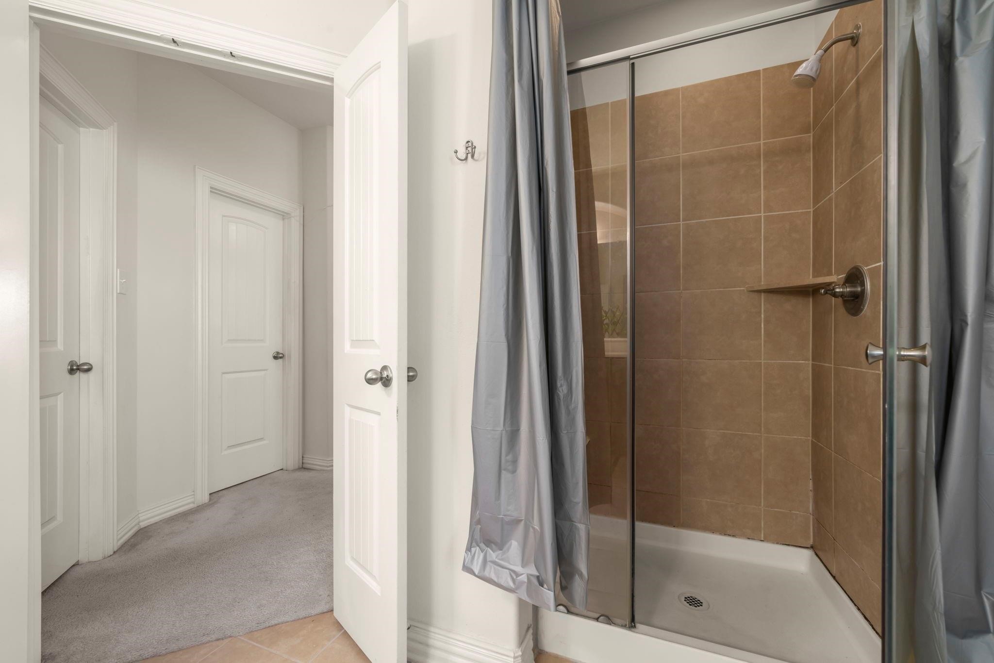 9939 Clear Diamond Drive Rosharon, TX 77583 - Photo 21 of 30 a bathroom with a glass shower door