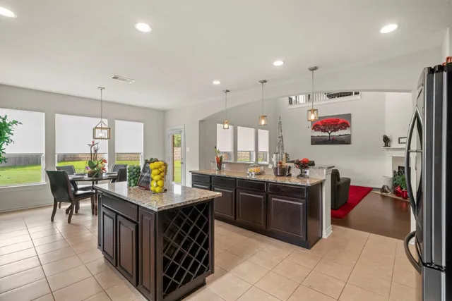 a kitchen with stainless steel appliances granite countertop a stove and a refrigerator