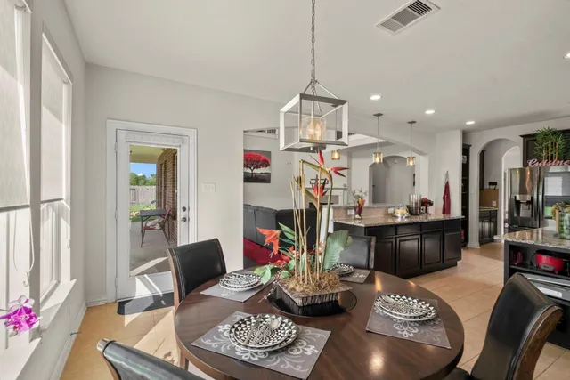 a living room with furniture and a dining table with kitchen view