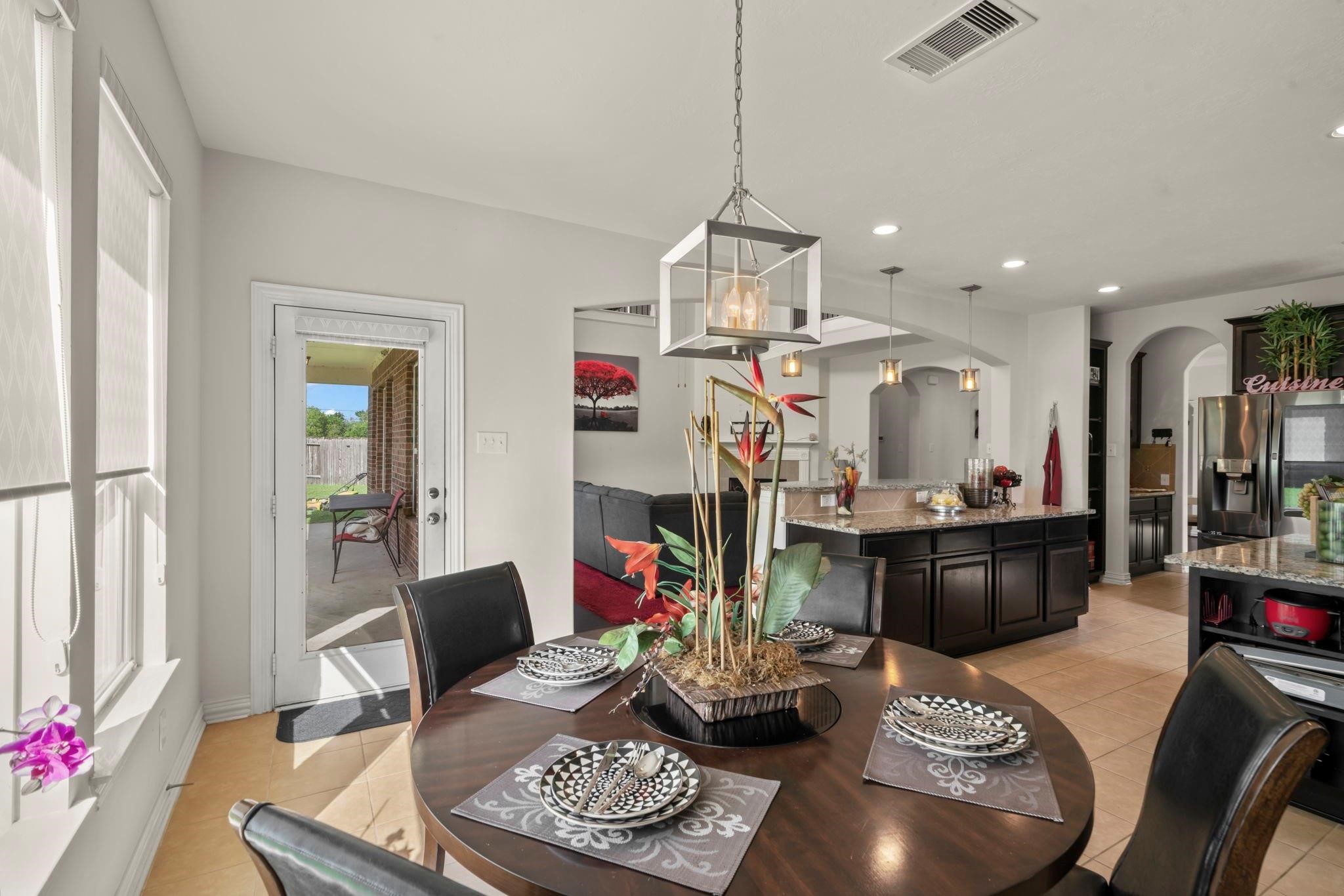9939 Clear Diamond Drive Rosharon, TX 77583 - Photo 5 of 30 a living room with furniture and a dining table with kitchen view