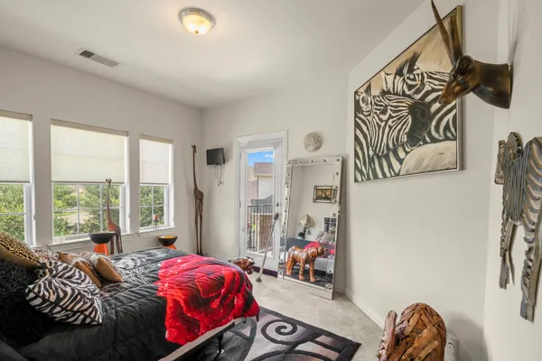 a bedroom with bed and a window