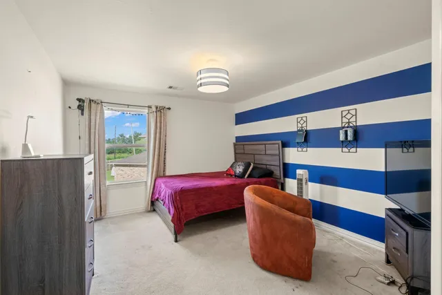 a living room with furniture and a ceiling fan