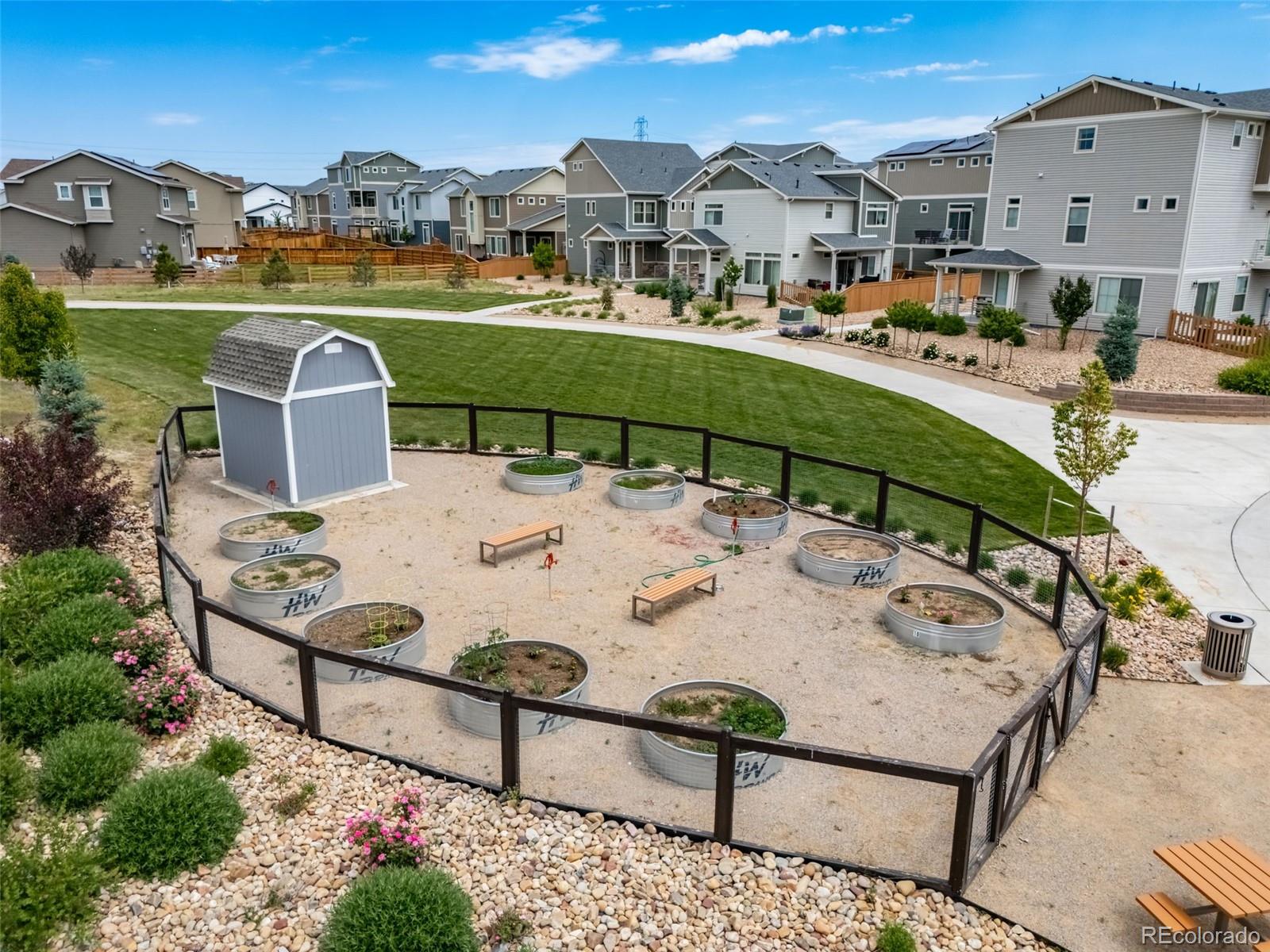 10175 Scranton Way Commerce City, CO 80022 - Photo 15 of 17 a view of a patio with table and chairs under an umbrella