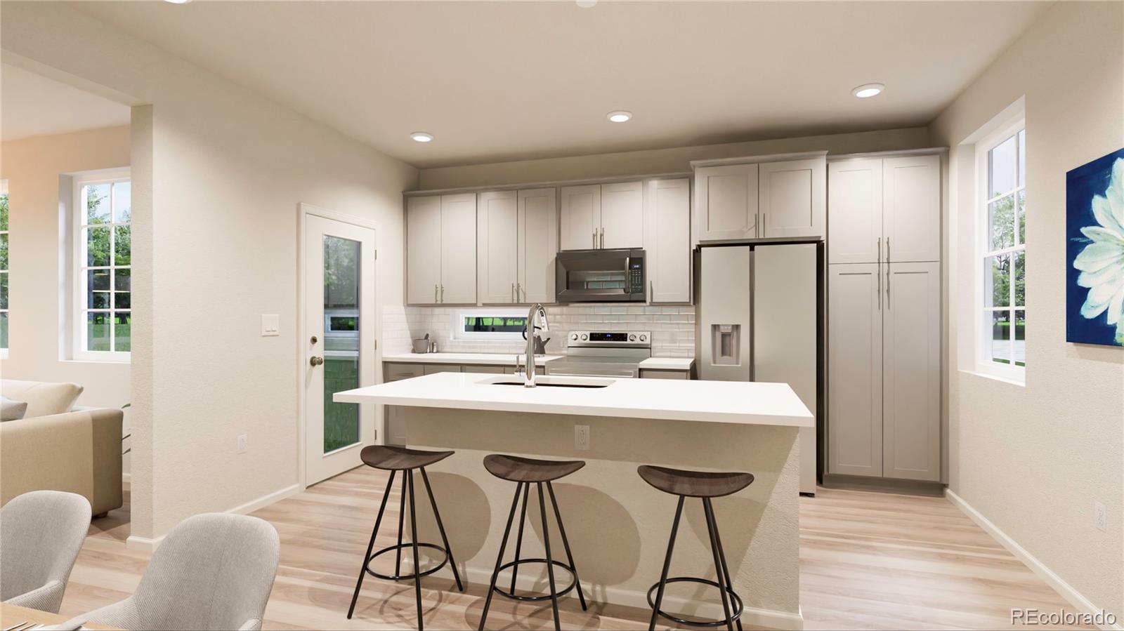 10175 Scranton Way Commerce City, CO 80022 - Photo 5 of 17 a kitchen with stainless steel appliances a dining table chairs refrigerator and cabinets