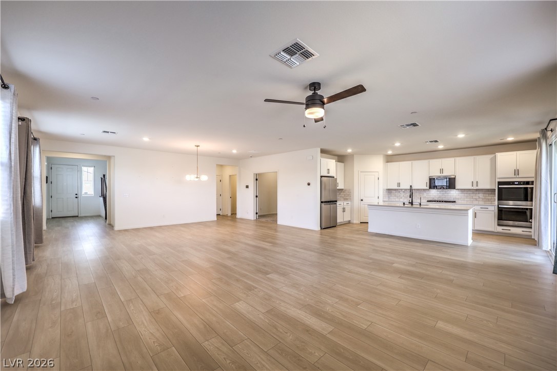 3782 Alla Rocca Avenue Henderson, NV 89044 - Photo 9 of 55 This expansive layout connects living and cooking areas, featuring elegant flooring and modern fixtures.