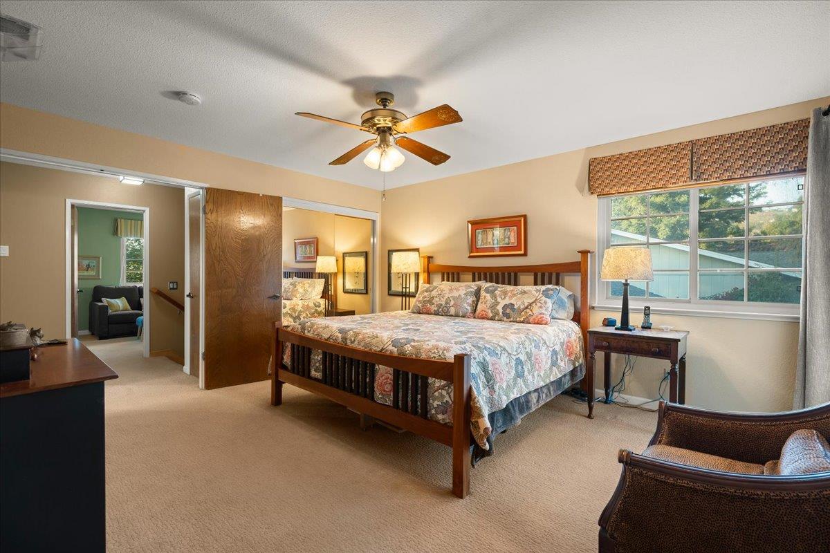 16715 Trail Drive Morgan Hill, CA 95037 - Photo 27 of 45 a spacious bedroom with a bed couch and a window