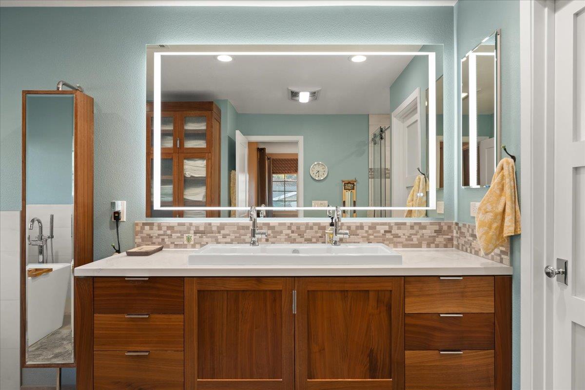 16715 Trail Drive Morgan Hill, CA 95037 - Photo 30 of 45 a bathroom with a granite countertop sink and a mirror