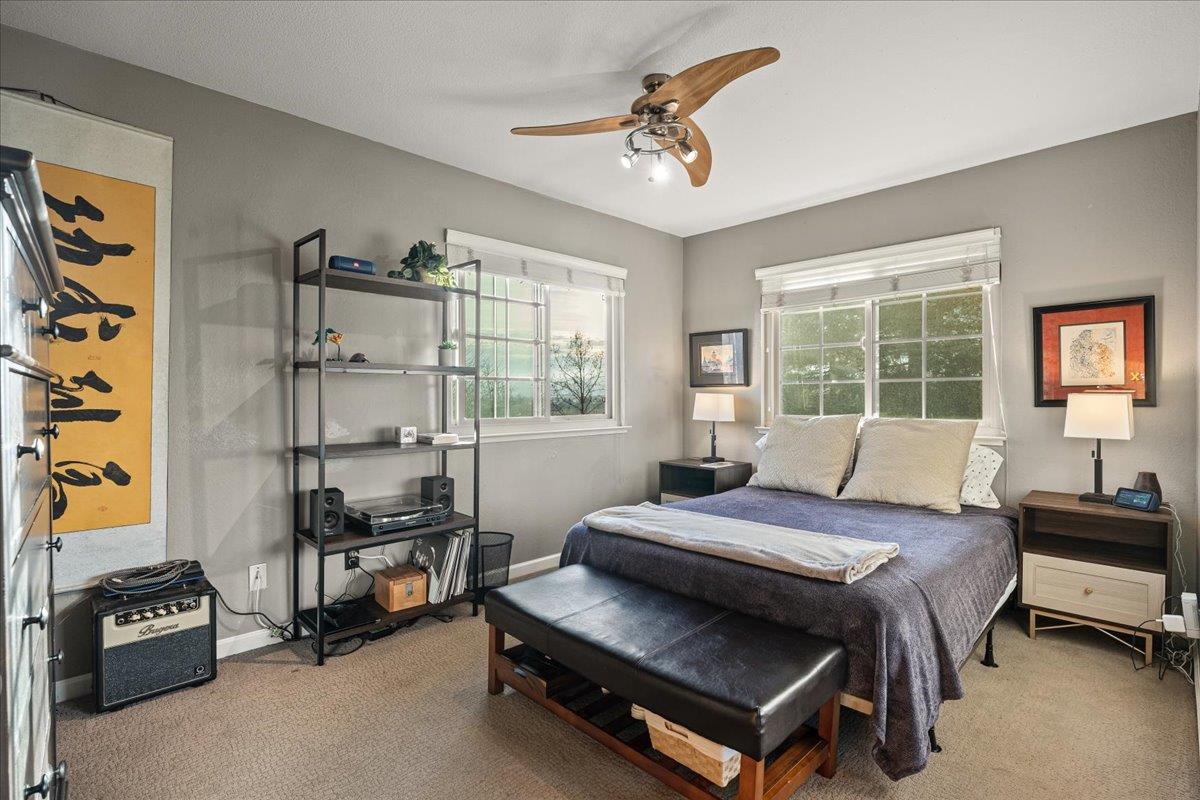 16715 Trail Drive Morgan Hill, CA 95037 - Photo 33 of 45 a bedroom with a bed and a chandelier