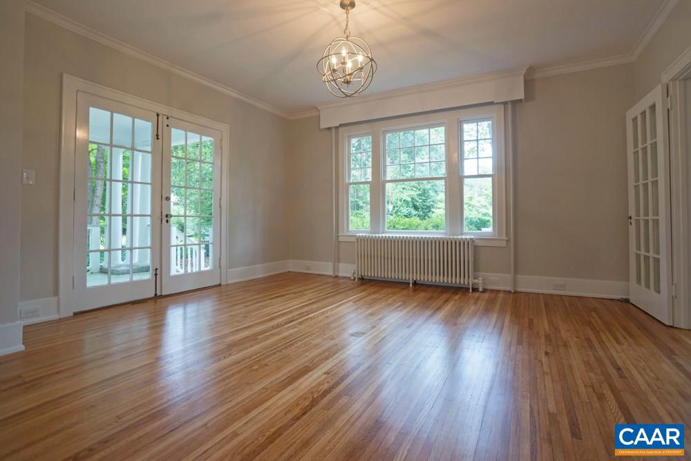 1930 Thomson Road Charlottesville, VA 22903 - Photo 13 of 35 a view of an empty room with wooden floor and a window