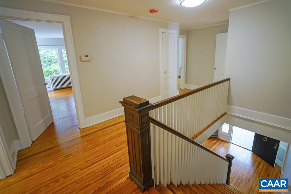 1930 Thomson Road Charlottesville, VA 22903 - Photo 16 of 35 a view of a hallway with wooden floor and stairs