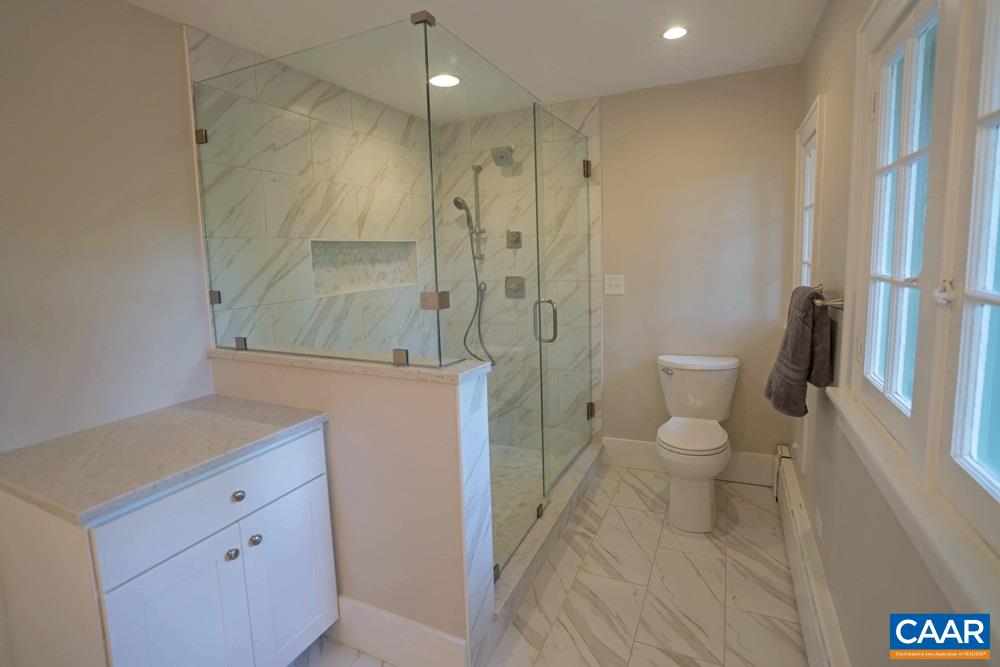 1930 Thomson Road Charlottesville, VA 22903 - Photo 19 of 35 a bathroom with a granite countertop sink toilet and shower
