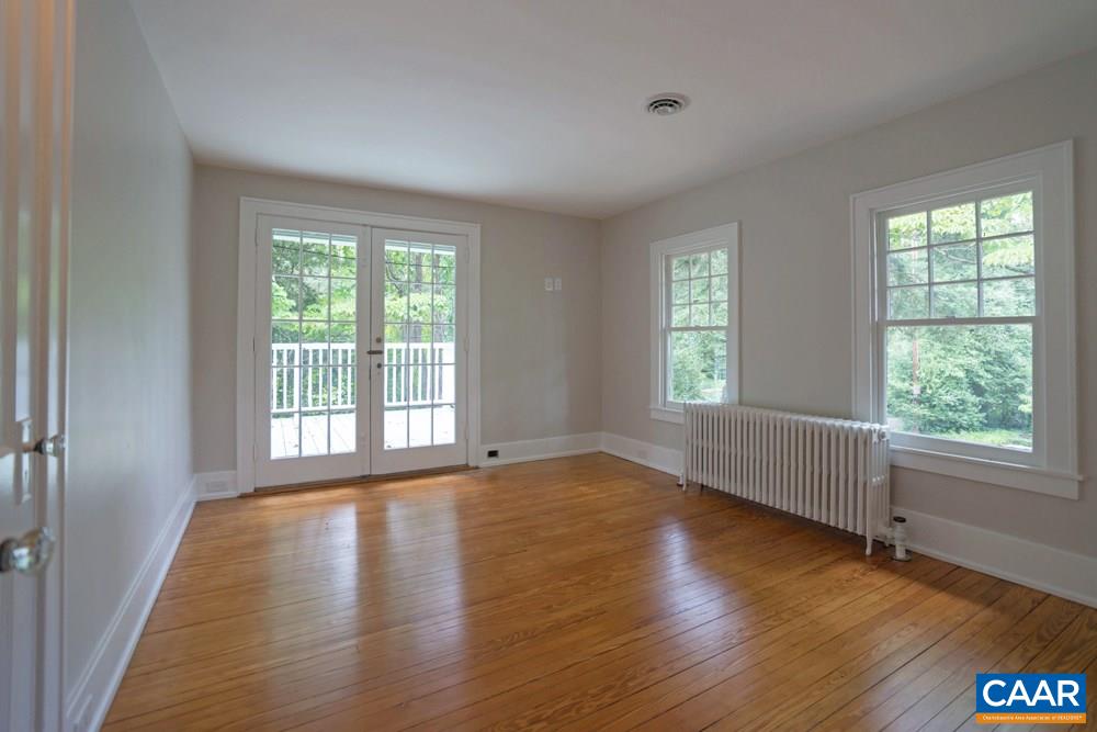 1930 Thomson Road Charlottesville, VA 22903 - Photo 23 of 35 a view of an empty room with wooden floor and a window