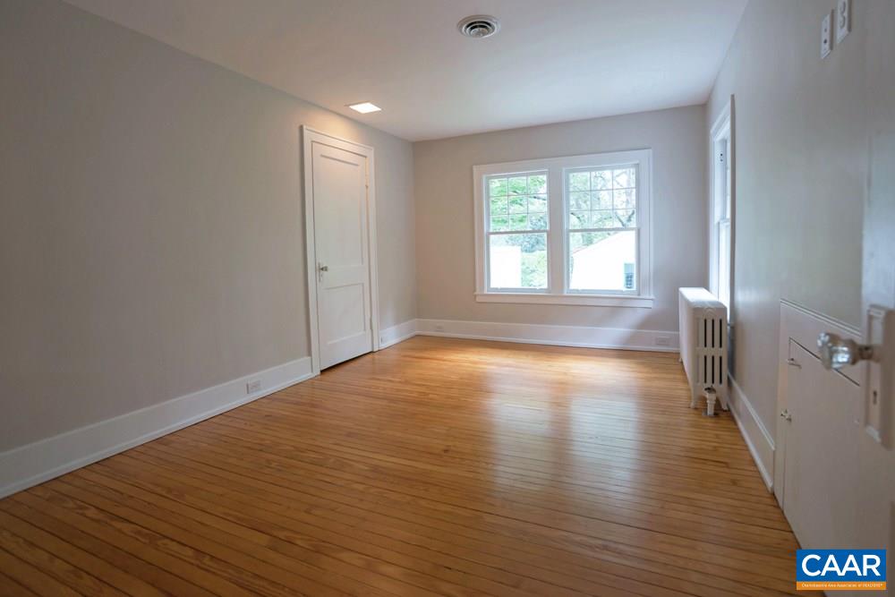 1930 Thomson Road Charlottesville, VA 22903 - Photo 24 of 35 a view of empty room with wooden floor and fan