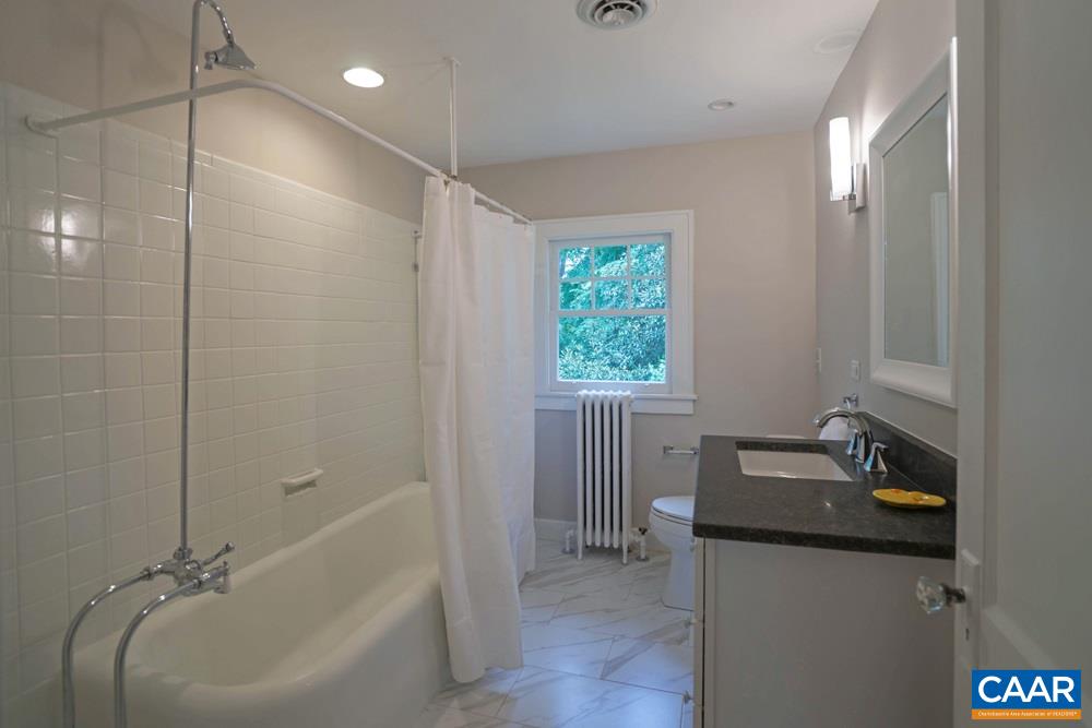 1930 Thomson Road Charlottesville, VA 22903 - Photo 25 of 35 a bathroom with a tub a sink and mirror