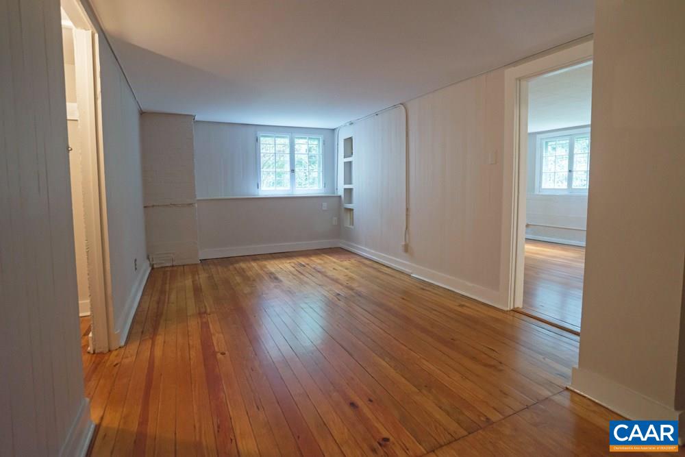 1930 Thomson Road Charlottesville, VA 22903 - Photo 28 of 35 a view of empty room with wooden floor and fan