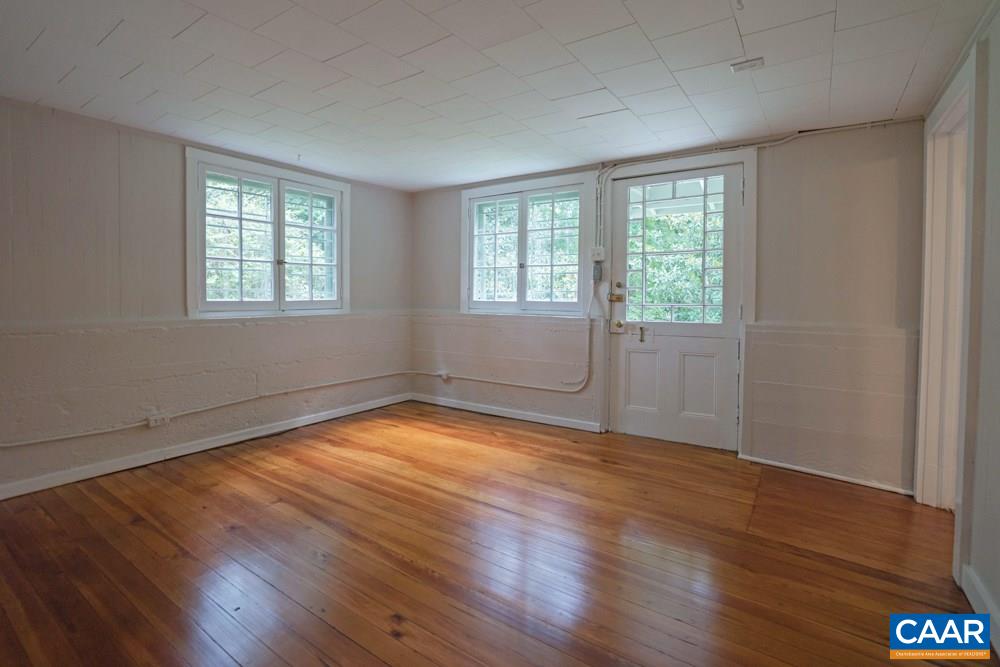 1930 Thomson Road Charlottesville, VA 22903 - Photo 29 of 35 an empty room with wooden floor and windows