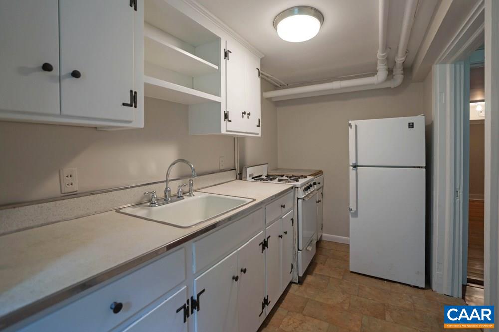 1930 Thomson Road Charlottesville, VA 22903 - Photo 30 of 35 a kitchen with a sink and a refrigerator