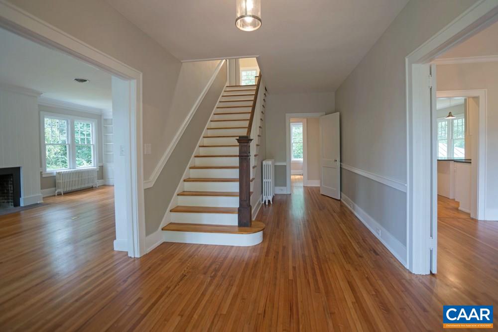1930 Thomson Road Charlottesville, VA 22903 - Photo 3 of 35 a view of a hallway with wooden floor and stairs