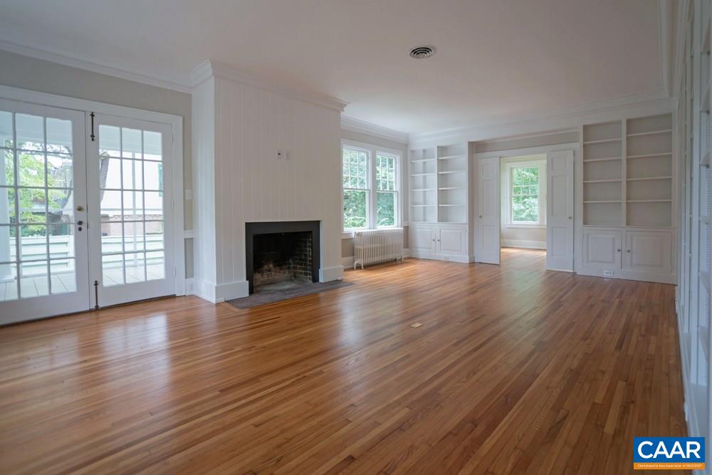 1930 Thomson Road Charlottesville, VA 22903 - Photo 4 of 35 a view of an empty room with wooden floor and a window