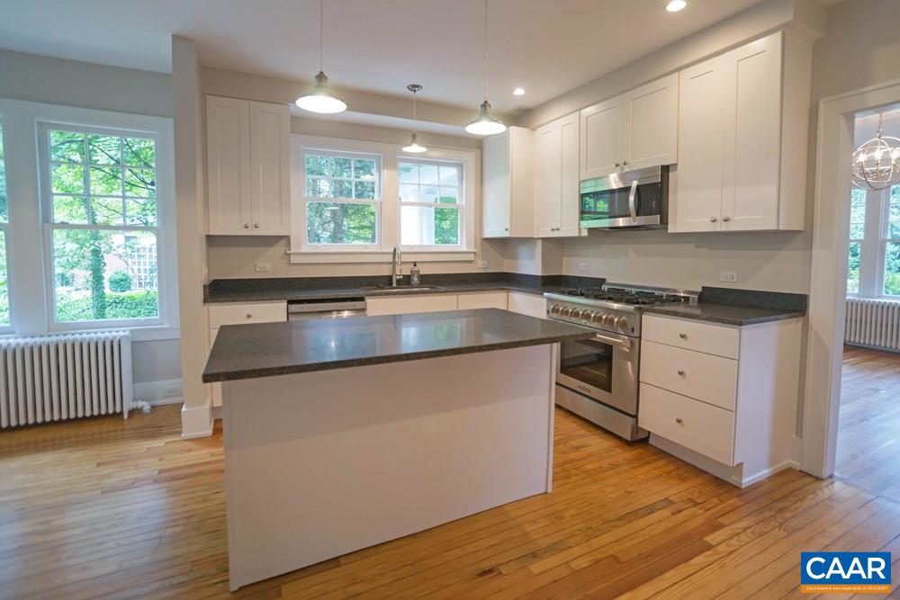 1930 Thomson Road Charlottesville, VA 22903 - Photo 8 of 35 a kitchen with white cabinets appliances a sink and a window