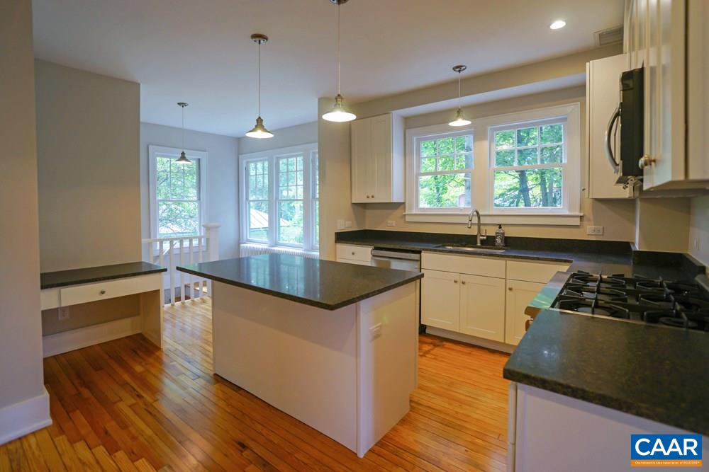1930 Thomson Road Charlottesville, VA 22903 - Photo 9 of 35 a kitchen with granite countertop a stove a sink and a refrigerator