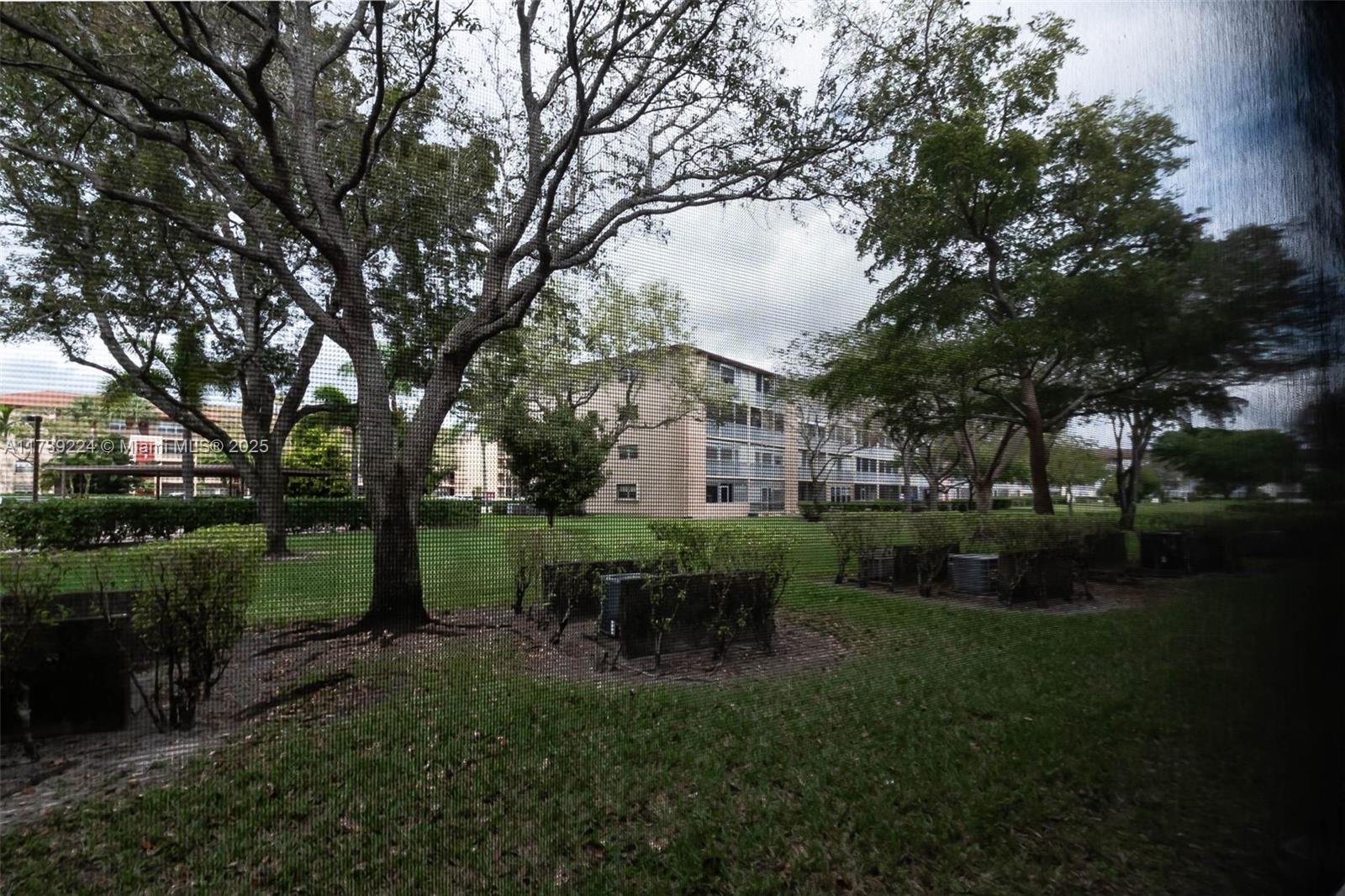 13355 Southwest 9th Court, Unit 104H Pembroke Pines, FL 33027 - Photo 19 of 22 a view of a house with garden and a chairs