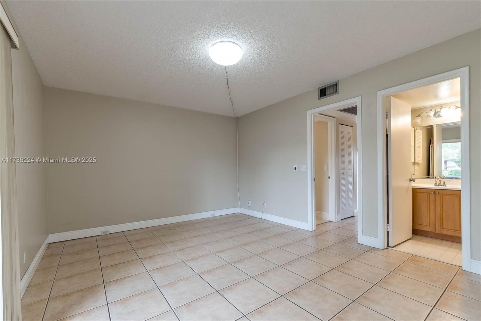 13355 Southwest 9th Court, Unit 104H Pembroke Pines, FL 33027 - Photo 6 of 22 a view of an empty room and window