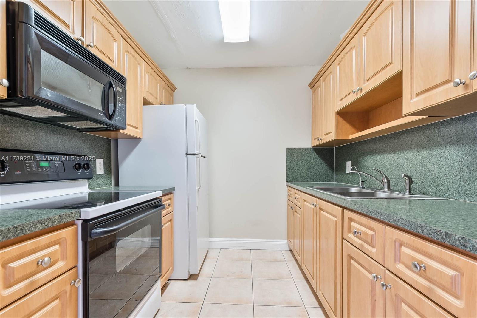 13355 Southwest 9th Court, Unit 104H Pembroke Pines, FL 33027 - Photo 10 of 22 a kitchen with stainless steel appliances granite countertop a sink and a stove