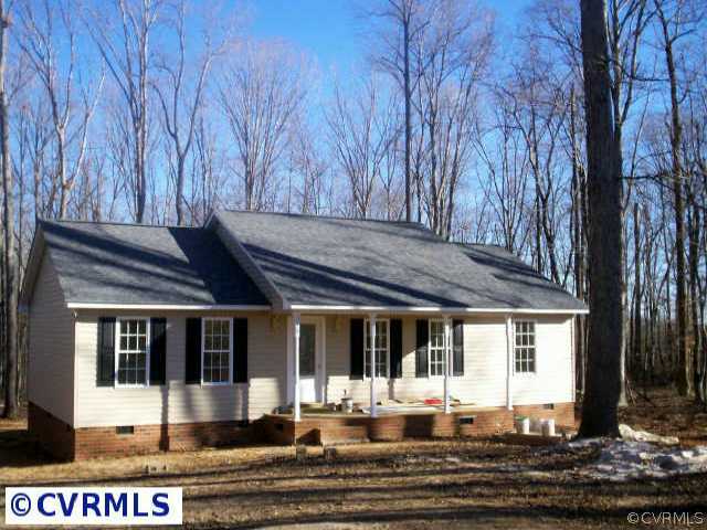 a front view of a house with a yard table and chairs