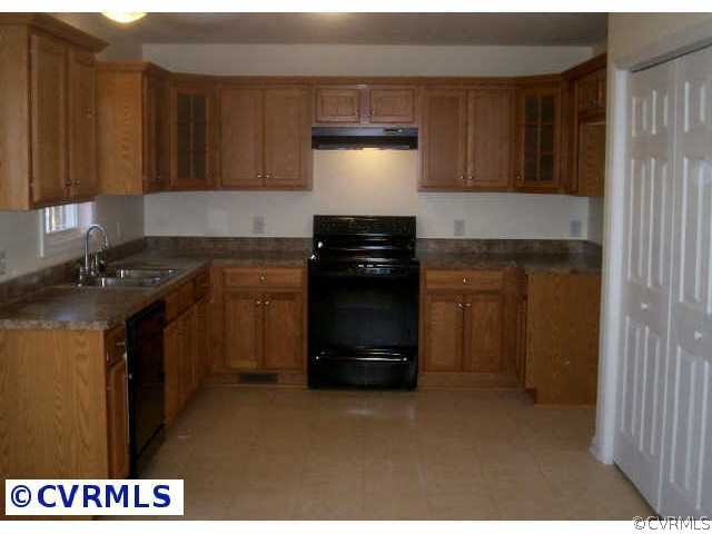 239 Old Buckingham Road Cumberland, VA 23040 - Photo 3 of 5 a kitchen with a stove and a cabinet