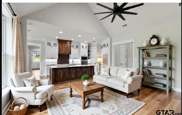 a living room with furniture and a wooden floor