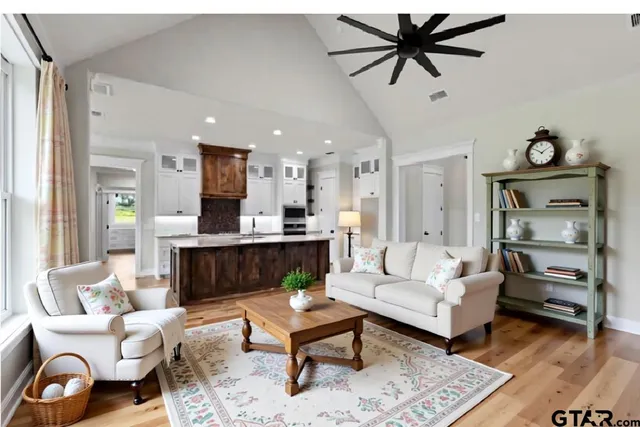 a view of empty room with wooden floor and fireplace