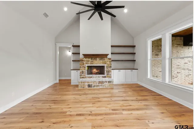 a view of a kitchen with a sink and wooden floor