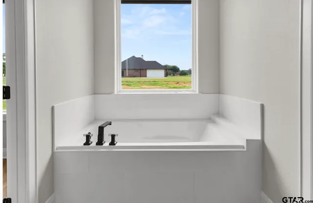 a bathroom with a sink a mirror and shower