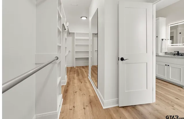 a view of walk in closet with empty racks