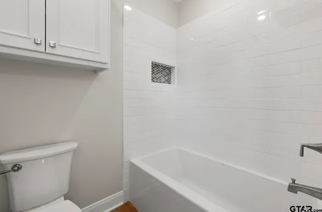 an empty room with a window and wooden floor