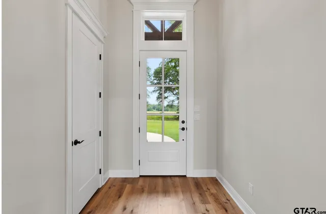 a view of an entryway with wooden floor
