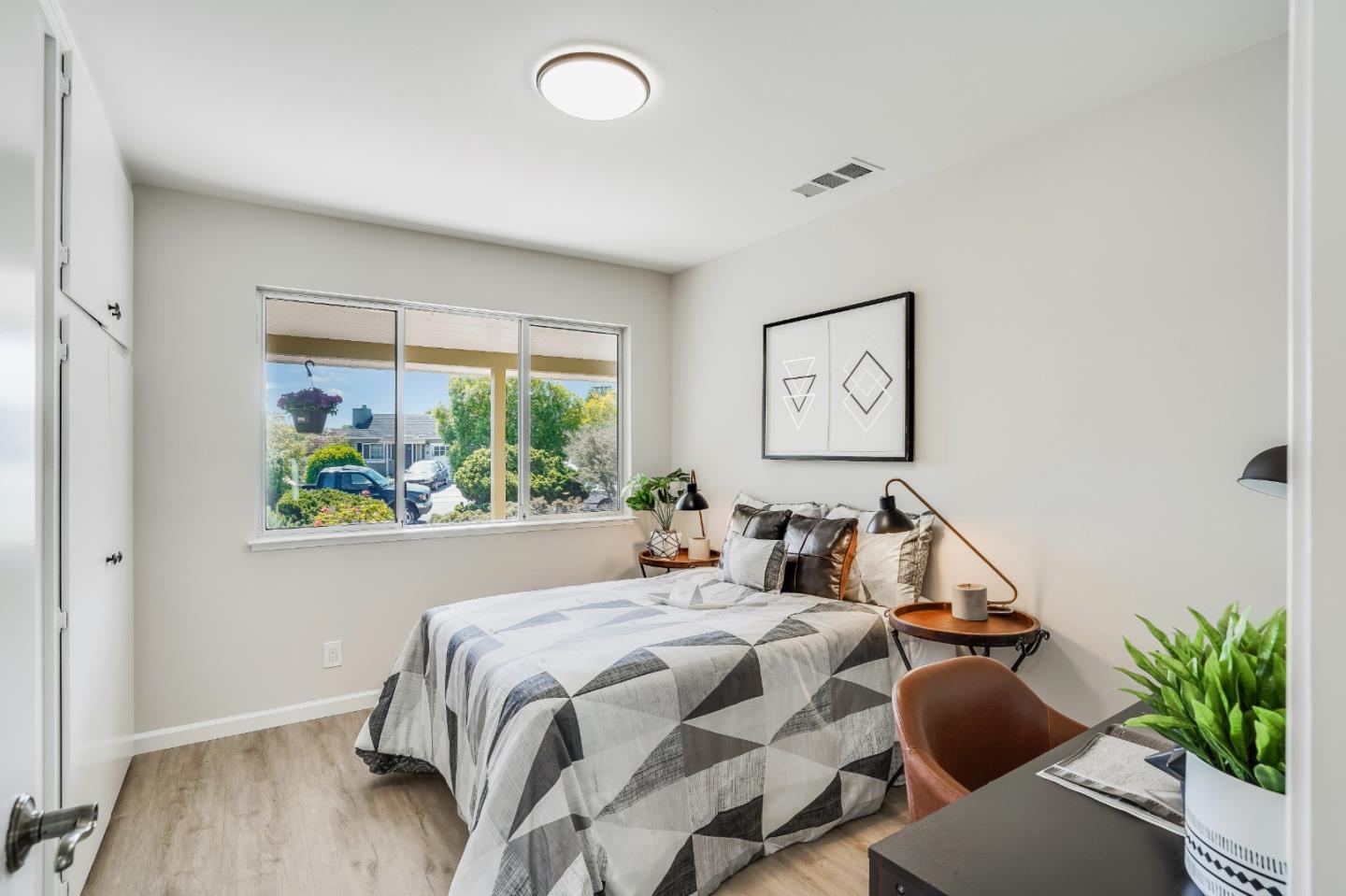 508 Mountain View Avenue Belmont, CA 94002 - Photo 12 of 38 a bed room with a bed and a painting on the wall